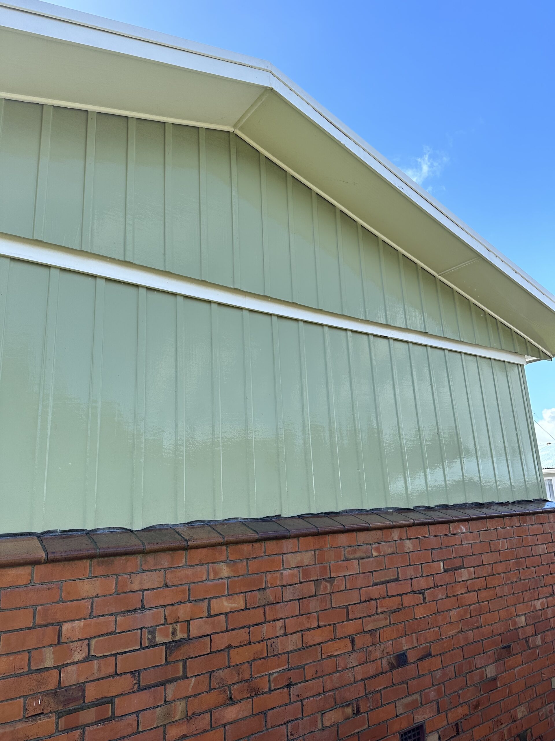 Clean restored exterior cladding and architectural surfaces following low-pressure soft wash treatment